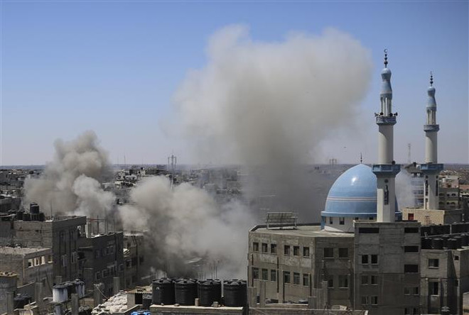 Khói bốc lên sau loạt không kích của Israel xuống Dải Gaza ngày 15/5. (Ảnh: THX/TTXVN) Xung đột Israel-Palestine: Israel không kích dữ dội thành phố Gaza ảnh 1