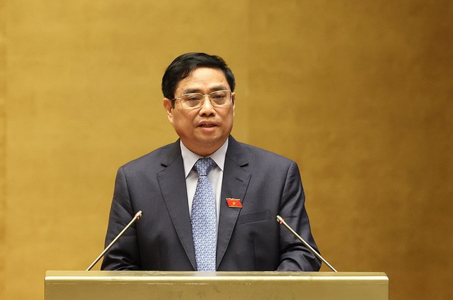 Thủ tướng Chính phủ Phạm Minh Chính trình bày Báo cáo. (Ảnh: Dương Giang/TTXVN) Đưa đất nước tiến lên trên con đường đổi mới, hội nhập và phát triển ảnh 1