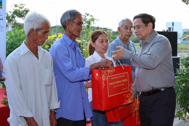 Thủ tướng Phạm Minh Chính tặng quà cho nhân dân Khu tái định cư Long Bửu, quận Thủ Đức. (Ảnh: Dương Giang/TTXVN) Thủ tướng Phạm Minh Chính khảo sát dự án Đường vành đai 3 tại TP.HCM ảnh 1