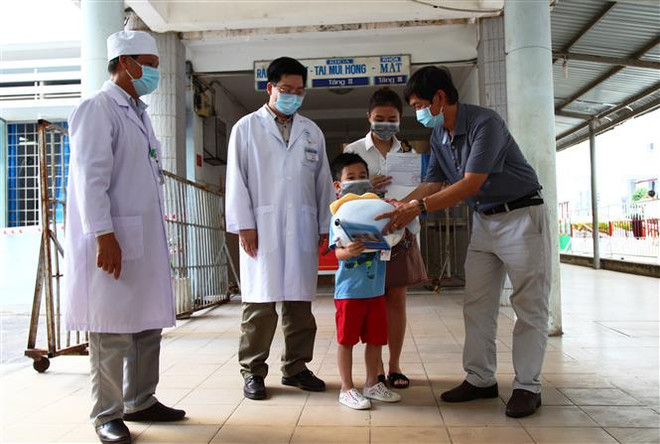 Lãnh đạo Sở Y tế Tây Ninh cùng Ban Giám đốc Bệnh viện Đa khoa tỉnh Tây Ninh trao quà chúc mừng bệnh nhân 252 khỏi bệnh. (Ảnh: Thanh Tân/TTXVN) Ý thức của người dân là vắcxin tốt nhất để đẩy lùi dịch COVID-19 ảnh 3