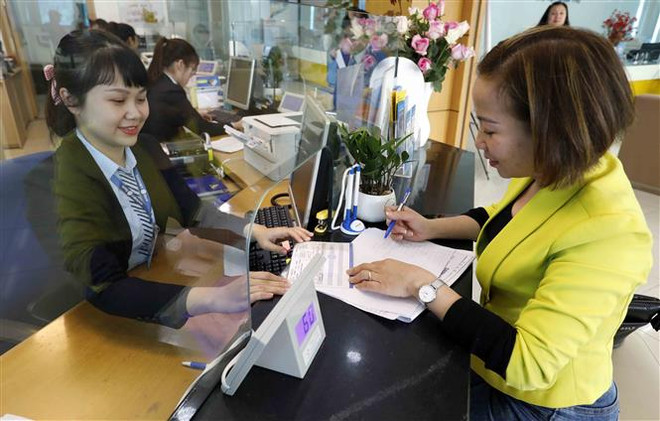 Ảnh minh họa. (Ảnh: Trần Việt/TTXVN) Tránh hiểu lầm khi mua trái phiếu doanh nghiệp qua ngân hàng ảnh 1