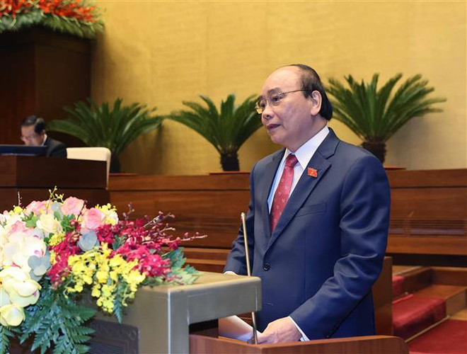 Thủ tướng Nguyễn Xuân Phúc trình bày báo cáo tổng kết của Chính phủ nhiệm kỳ 2016-2021 tại phiên khai mạc Kỳ họp lần thứ 11, Quốc hội khóa XIV. (Ảnh: Thống Nhất/TTXVN) Thủ tướng chủ trì tổng kết nhiệm kỳ Chính phủ khóa 2016-2021 ảnh 1