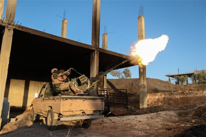 Tay súng thuộc nhóm cực đoan có liên hệ với tổ chức al-Qaeda đụng độ với lực lượng ủng hộ chính quyền ở tỉnh Idlib, Syria. (Ảnh: AFP/TTXVN) Quân đội Syria đạt bước tiến quan trọng ở tỉnh Idlib ảnh 1