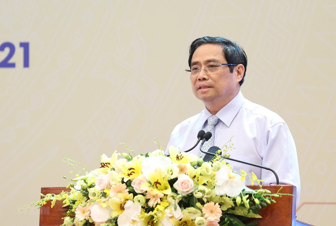 Thủ tướng Phạm Minh Chính phát biểu tại hội nghị. (Ảnh: Dương Giang/TTXVN) Thủ tướng: Phải thích ứng an toàn, linh hoạt với dịch bệnh COVID-19 ảnh 1