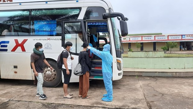 Tiếp nhận và kiểm tra thân nhiệt cộng đồng người Việt nhập cảnh để đưa về cách ly tập trung. (Ảnh: TTXVN phát) Việt Nam ghi nhận thêm 12 ca mắc COVID-19 mới, đều được cách ly ngay ảnh 2