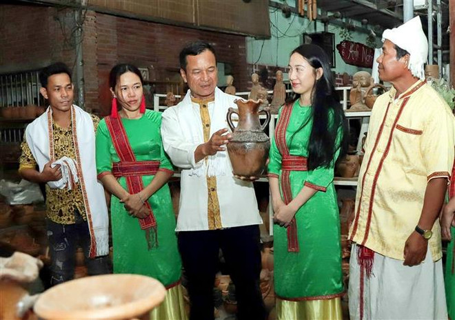 Ông Đàng Chí Quyết giới thiệu với du khách về gốm truyền thống của làng nghề. (Ảnh: TTXVN phát) Nỗ lực vì sự phát triển của Làng nghề Gốm truyền thống Bàu Trúc ảnh 1