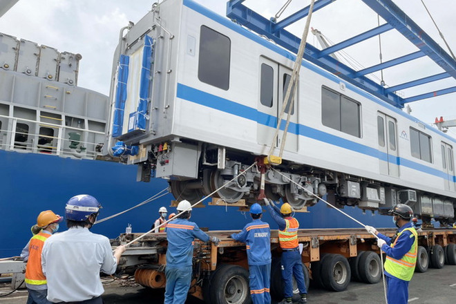 Các chuyên gia, kỹ sư, công nhân đưa toa xe xuống xe vận chuyển chuyên dụng. (Ảnh: TTXVN phát) Xây dựng 2 kịch bản khôi phục thi công metro số 1 Bến Thành-Suối Tiên ảnh 1