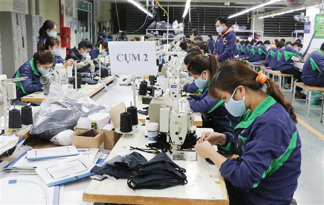 Một góc dây chuyền sản xuất khẩu trang kháng khuẩn của Công ty cổ phần đầu tư và thương mại TNG. (Ảnh: Hoàng Nguyên/TTXVN) Kết nối cung cấp ra thị trường 300.000 khẩu trang kháng khuẩn ảnh 1