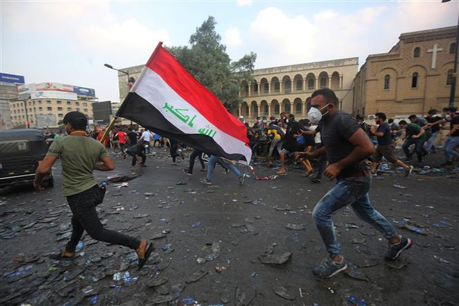 Người biểu tình Iraq tại cây cầu al-Jumhuriya dẫn đến Vùng Xanh, nơi được bảo vệ nghiêm ngặt ở thủ đô Baghdad. (Ảnh: AFP/TTXVN) Trung Đông bước vào giai đoạn hậu chia rẽ giáo phái? ảnh 2