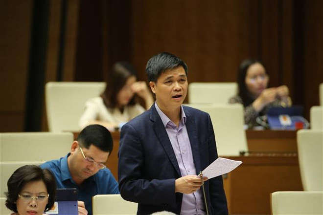 Đại biểu Quốc hội Thành phố Hà Nội Ngọ Duy Hiểu phát biểu ý kiến về dự án Luật sửa đổi, bổ sung một số điều của Luật Tổ chức Quốc hội. (Ảnh: Dương Giang/TTXVN) Đề xuất không ''công chức hóa'' đại biểu Quốc hội chuyên trách ảnh 2