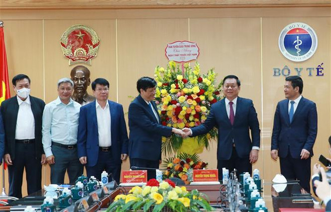 Trưởng Ban Tuyên giáo Trung ương Nguyễn Trọng Nghĩa tặng hoa chúc mừng cán bộ, nhân viên Bộ Y tế. (Ảnh: Phương Hoa/TTXVN) Lan tỏa tấm gương cán bộ ngành y trên tuyến đầu chống dịch ảnh 1