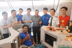 Lãnh đạo VFF, Ban huấn luyện đội tuyển và tiền đạo Xuân Son chụp ảnh chung khi máy bay vừa hạ cánh. (Ảnh: Minh Quyết/TTXVN)