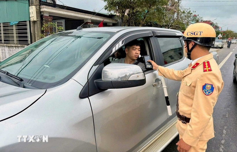 Lực lượng cảnh sát giao thông đo nồng độ cồn người tham gia giao thông trong những ngày nghỉ Tết. (Ảnh: Công Tường/TTXVN)