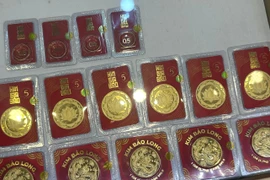 Giá vàng trong nước tăng giảm trái chiều nhau, tỷ giá trung tâm tăng nhẹ. (Ảnh: Vietnam+)