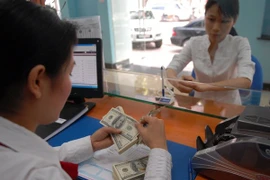 Ngân hàng UOB dự đánh giá USD sẽ tiếp tục suy yếu. (Ảnh: Vietnam+)