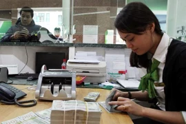  Ngân hàng Nhà nước lý giải nguyên nhân tỷ giá tăng khi USD thế giới giảm. (Ảnh: Vietnam+)