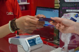 Khách hàng thanh toán không tiền mặt nhanh chóng thông qua nền tảng Payoo - Đây là thành quả của sự hợp tác giữa VietinBank và VietUnion. (Ảnh: Vietnam+)