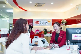 Người có mức lương dưới 15 triệu đồng/tháng nay thêm cơ hội chạm tới ngôi nhà mơ ước, chỉ với khoản góp từ 200.000 đồng mỗi ngày. (Ảnh: Vietnam+)