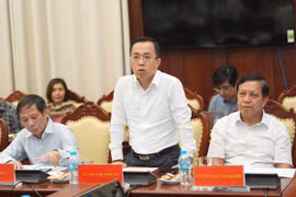 Ông Lê Hoàng Chính Quang - Cục trưởng Cục Công nghệ thông tin Ngân hàng Nhà nước chia sẻ tại họp báo. (Ảnh: Vietnam+)