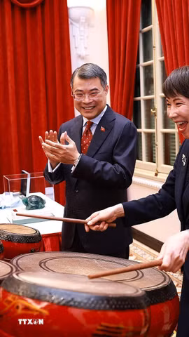 Thủ tướng Nhật Bản Takaichi Sanae trải nghiệm đánh trống - sản phẩm âm nhạc truyền thống của Việt Nam. (Ảnh: Dương Giang/TTXVN)
