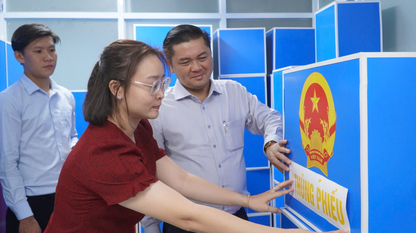 Ông Lê Lợi (trái), Phó Chủ tịch Ủy ban bầu cử phường Phú Thuận kiểm tra tiến độ công tác bầu cử tại địa phương. (Ảnh: Khánh Ly/Vietnam+)