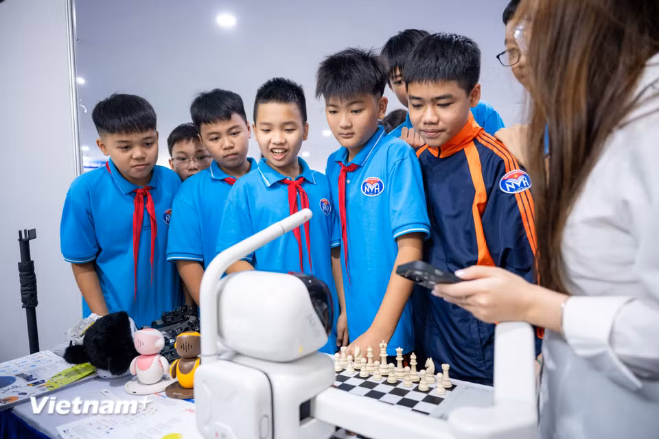 Tại một gian hàng, những ván cờ vua diễn ra giữa người chơi và một đối thủ đặc biệt: robot chơi cờ ứng dụng AI. Tại đây, những màn "đấu trí" đầy cam go và thú vị khi các em có cơ hội trực tiếp so tài với một đối thủ không phải con người. (Ảnh: Minh Sơn/Vietnam+)