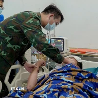 Các bác sỹ tích cực cấp cứu cho người bệnh tại Trạm xá đảo Sinh Tồn. (Ảnh: TTXVN phát)