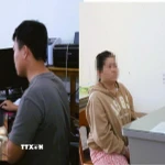 Đối tượng Nguyễn Phạm Ngọc Lâm và Lê Thị Ngọc Hạnh tại cơ quan điều tra. (Ảnh: Công an Đồng Nai/ TTXVN phát)