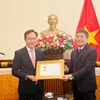 Thứ trưởng thường trực Bộ Ngoại giao Nguyễn Minh Vũ trao Kỷ niệm chương “Vì sự nghiệp ngoại giao Việt Nam” cho ông Choi Joo Ho, Tổng giám đốc Tổ hợp Samsung Việt Nam. (Nguồn: TTXVN)