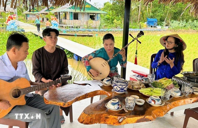 Biểu diễn đờn ca tài tử ở điểm du lịch sinh thái nông nghiệp Cánh Đồng Cậu Ba. (Ảnh: TTXVN phát) ttxvn-don-ca-tai-tu-1005-1.jpg