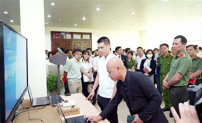 Các đại biểu tham quan mô hình ứng dụng căn cước công dân gắn chip điện tử, VNEID phục vụ kiểm soát an ninh và chấm công tại Công ty Cổ phần Ximăng Xuân Thành. (Ảnh: Nguyễn Chinh/TTXVN) Ứng dụng căn cước công dân gắn chip kiểm soát an ninh và chấm công ảnh 1