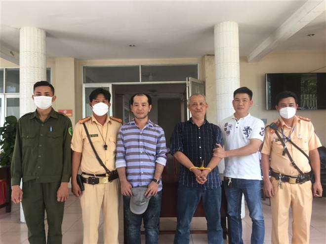 Trạm Cảnh sát giao thông thị xã Trảng Bàng tổ chức bàn giao 2 đối tượng trộm ôtô cho Công an thành phố Tây Ninh. (Ảnh: Thanh Tân/TTXVN) Tây Ninh: Bắt giữ 2 đối tượng lấy trộm xe ôtô có biểu hiện 'ngáo đá' ảnh 1