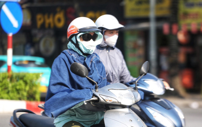 Người dân ra đường ngày nắng nóng thường bịt kín để đảm bảo sức khỏe. (Ảnh: Thu Phương/TTXVN phát) ttxvn_nang nong gay gat (3).jpeg