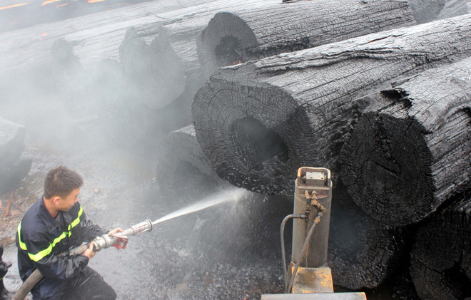 Lửa bùng phát dữ dội tại bãi tập kết gỗ, nhiều khối gỗ bị cháy đen ảnh 1