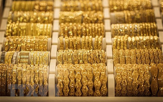 Ảnh minh họa (Nguồn: AFP/TTXVN) Giá vàng châu Á tăng trong phiên 30/12 khi đồng USD xuống giá ảnh 1