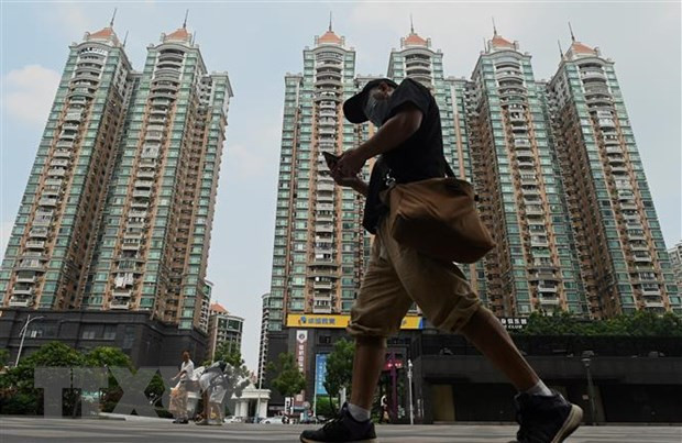Các tòa nhà do tập đoàn bất động sản Evergrande xây dựng tại Quảng Châu, Trung Quốc. (Ảnh: AFP/TTXVN) Tập đoàn Evergrande tái khởi động 10 dự án bất động sản ảnh 1