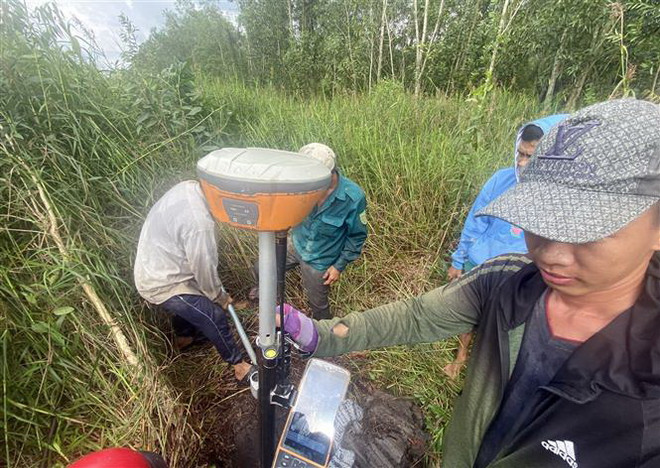 Đo tọa độ cắm mốc giải phóng mặt bằng thực hiện dự án Vành đai 3 tại huyện Bình Chánh, Thành phố Hồ Chí Minh. (Ảnh: Tiến Lực/TTXVN) Khởi công dự án Vành đai 3 đoạn qua Thành phố Hồ Chí Minh vào 18/6 ảnh 1
