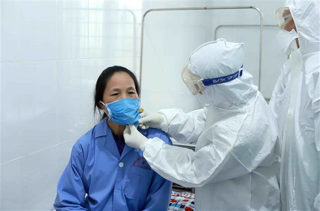 Bác sỹ Đội cơ động Bệnh viện Bạch Mai (Hà Nội) thăm khám cho bệnh nhân dương tính với virus corona chủng mới tại Trung tâm y tế huyện Bình Xuyên, Vĩnh Phúc. (Ảnh: Hoàng Hùng/TTXVN) 'Việt Nam đã có phác đồ điều trị hiệu quả đối với COVID-19' ảnh 1