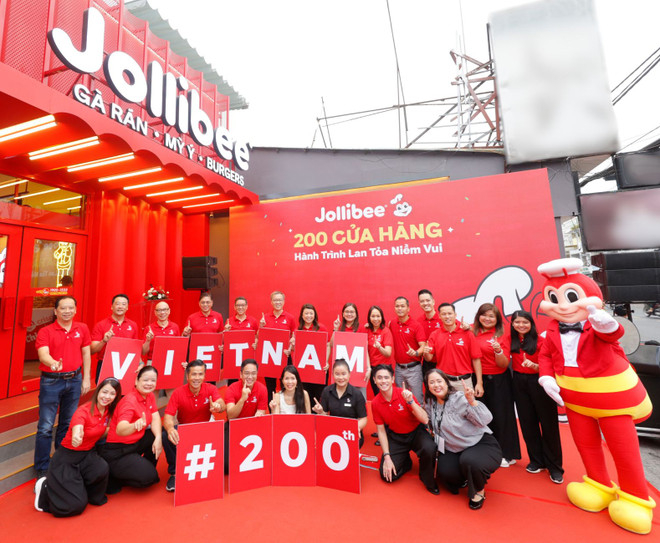 Jollibee Group celebrates the opening of its 200th Jollibee Store in Vietnam, solidifying its position as one of the top restaurant chains in the country. The ceremony was led by Jollibee Group executives, including Jollibee Group Global Chief Executive Officer Ernesto Tanmantiong (2nd row, 5th from left); Jollibee Group Philippines CEO and Jollibee Global Head Joseph Tanbuntiong (2nd row, 6th from left); Jollibee Group Global Chief Business Support Officer William Tan Untiong (2nd row, 3rd from left); Jollibee Group Chief Financial and Risk Officer Richard Shin (2nd row, 2nd from left); Jollibee EMEAA President Dennis Flores (2nd row, 4th from left); Jollibee Vietnam Managing Director Lam Hong Nguyen (1st row, 3rd from left).