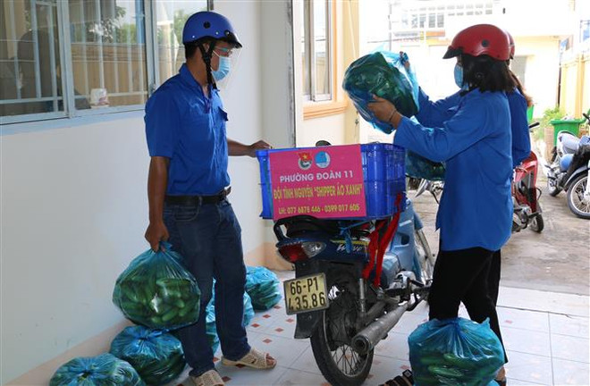 Đội hình 'shipper áo xanh' phường 11, thành phố Cao Lãnh (Đồng Tháp) giúp nông dân trên địa bàn tiêu thụ nông sản. (Ảnh: Chương Đài/TTXVN) Chuyện về những 'shipper áo xanh' đi chợ, thu mua nông sản giúp dân ảnh 2