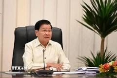 Tổng Bí thư, Chủ tịch nước Lào Thongloun Sisoulith phát biểu tại Lễ kỷ niệm. (Ảnh: Xuân Tú/TTXVN)