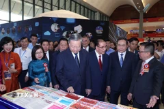 Tổng Bí thư Tô Lâm, các đồng chí lãnh đạo Đảng, Nhà nước và các đại biểu tham quan không gian trưng bày của TTXVN. (Ảnh: Thống Nhất/TTXVN)