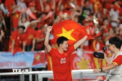 Các cầu thủ U22 Việt Nam hân hoan trong niềm vui chiến thắng. (Ảnh: Minh Quyết/TTXVN)