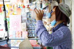 Người dân mưu sinh khi trời nắng nóng. (Ảnh: Lê Đông/TTXVN)