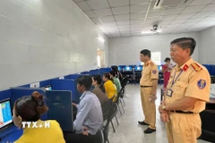 Lực lượng cảnh sát giao thông Công an tỉnh Bình Dương giám sát kỳ sát hạch. (Ảnh: Huyền Trang/TTXVN)