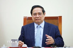 Thủ tướng Phạm Minh Chính điện đàm với Thủ tướng Qatar Sheikh Mohammed bin Abdulrahman Al Thani. (Ảnh: Dương Giang/TTXVN)