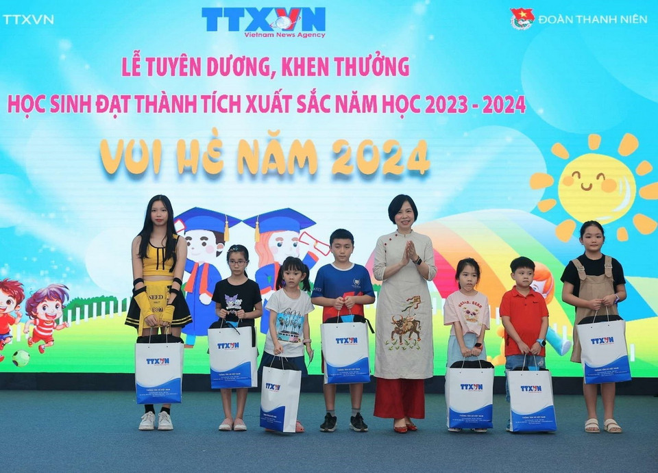 Tổng Giám đốc TTXVN Vũ Việt Trang trao phần thưởng tuyên dương học sinh đạt giải quốc tế. (Ảnh: Hoàng Hiếu/TTXVN)