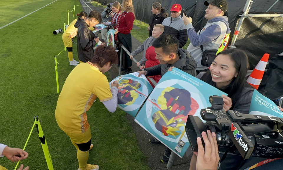 Cầu thủ Tuyển Bóng đá Nữ Việt Nam ký tên tặng người hâm mộ. (Ảnh: Trương Anh Ngọc/TTXVN)