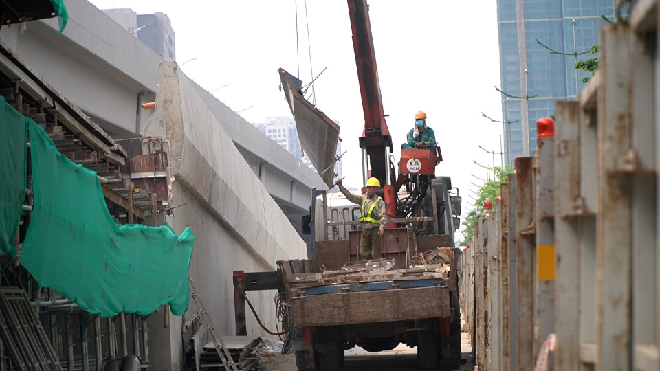 Công nhân lắp ráp giàn giáo nhánh Ram lên/xuống khu vực Hoàng Quốc Việt. (Ảnh: Văn Hào/Vietnam+)