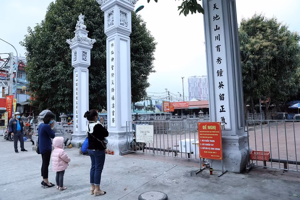 Vẫn còn nhiều người đến hành lễ bên ngoài tại khu di tích Đình - Chùa Bia Bà La Khê, quận Hà Đông dù đã có thông báo đóng cửa. (Ảnh: Phan Tuấn Anh/TTXVN)